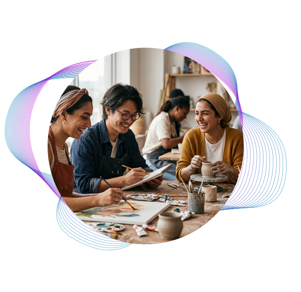 People smiling and creating art together during a studio workshop