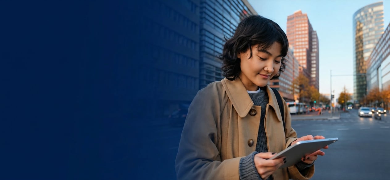 A community member reading on a tablet outdoors in the city