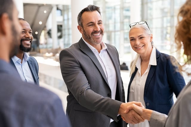 Business professionals shaking hands in a modern office